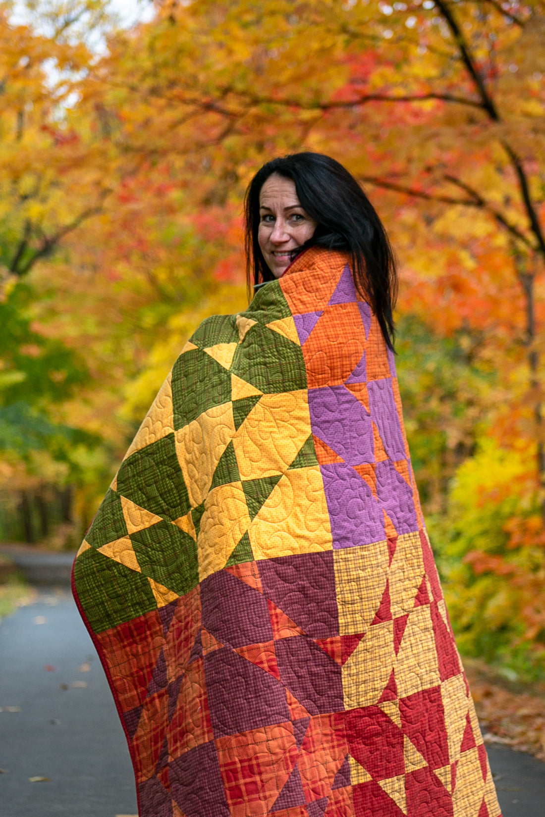 Gudrun Erla, founder of GE Designs, wrapped in one of her quilts