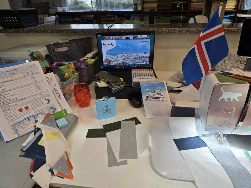 A sewing table set up for the retreat, with the Zoom class on a laptop
