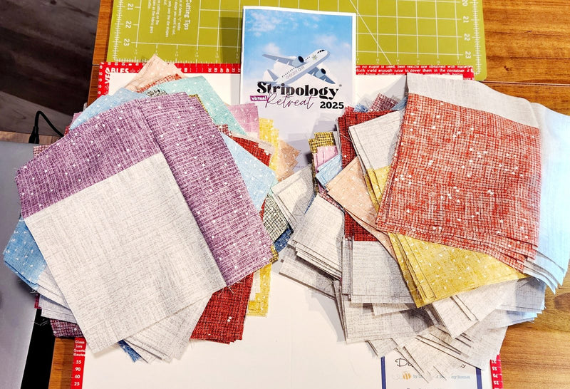 Stacks of retreat kit fabric laid out with the retreat card